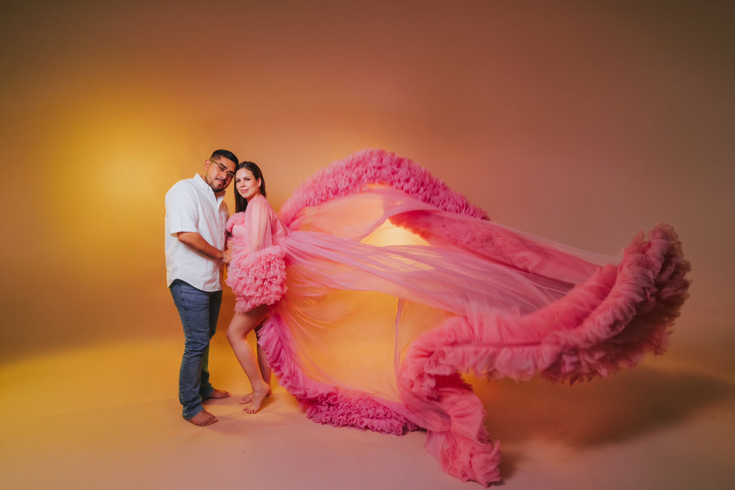 Retrato de maternidad con vestido rosa en movimiento